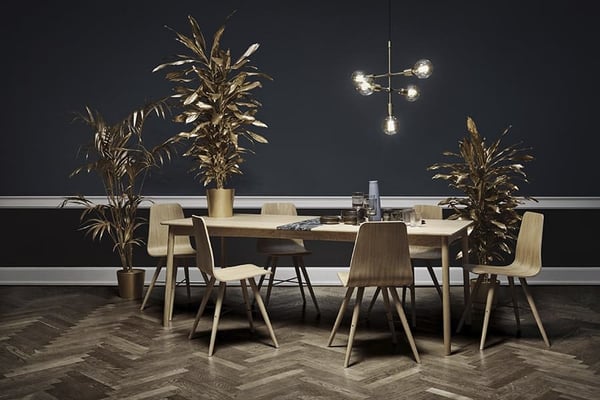 Image: Featuring Bolia's elegant dining room furniture in a room with stylish dark painted walls and a stunning fishbone-patterned wooden floor.