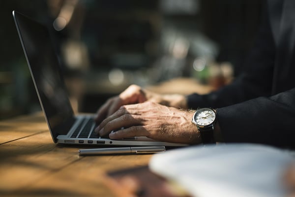 Picture of a Statens IT workforce management software customer's employee diligently working on a laptop, leveraging efficient tools for seamless operations.